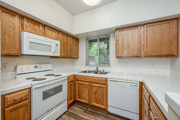 U Shape Kitchen - window  - Refrigerator - Dishwasher - Range - above range Microwave - Wood plank floors